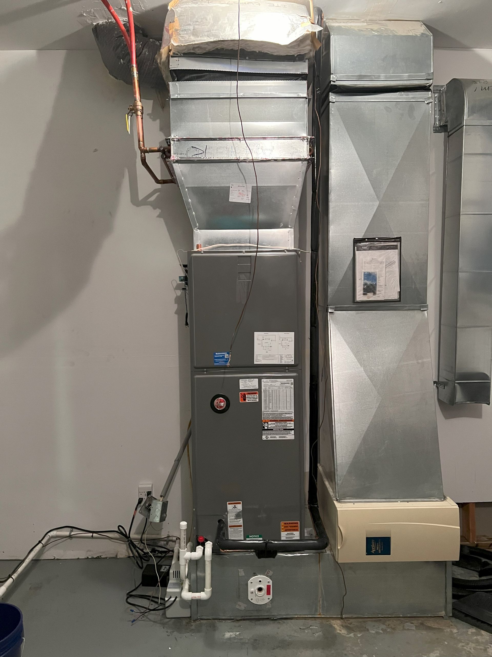 A heating and cooling system is installed in a basement.