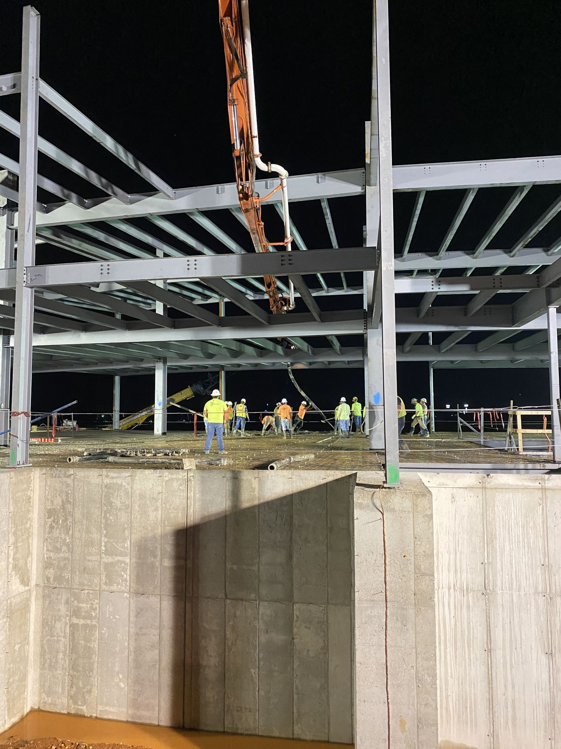 Interior of a wooden house under construction, showing framing, windows, and exposed beams.
