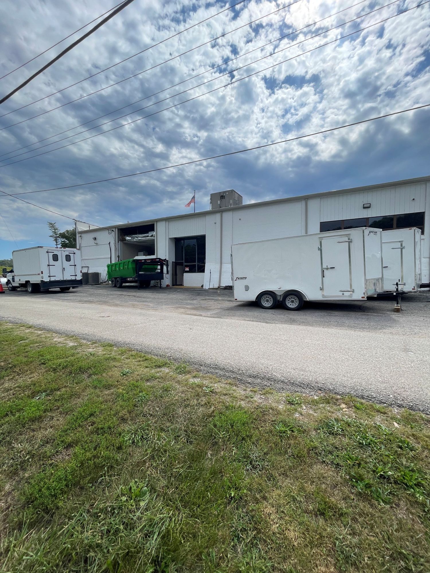 Interior of a wooden house under construction, showing framing, windows, and exposed beams.