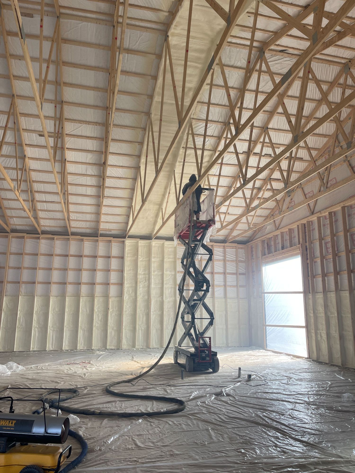 Interior of a modern cafe featuring a white brick wall, a long service counter with appliances, and green accent walls.