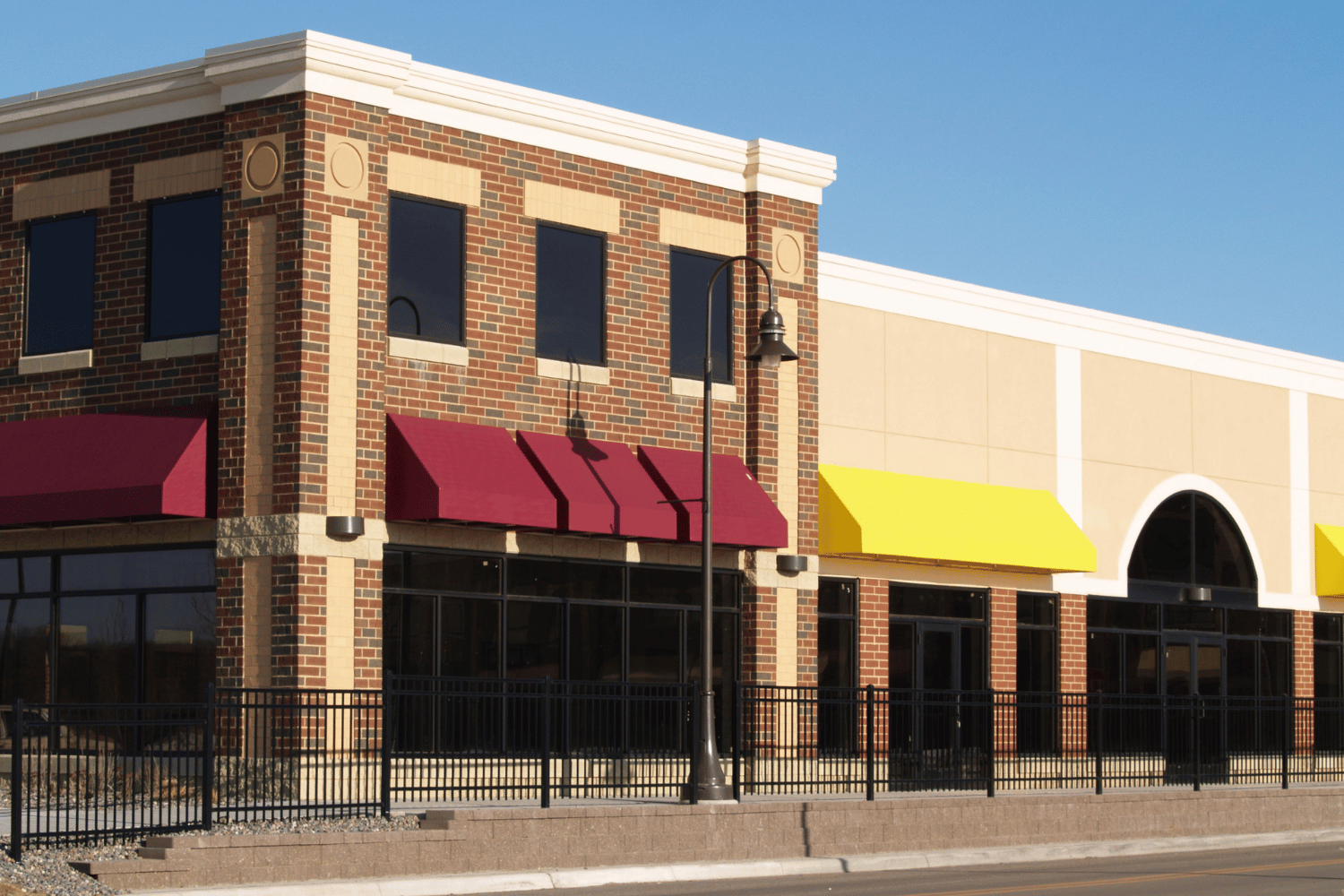 Interior of a wooden house under construction, showing framing, windows, and exposed beams.