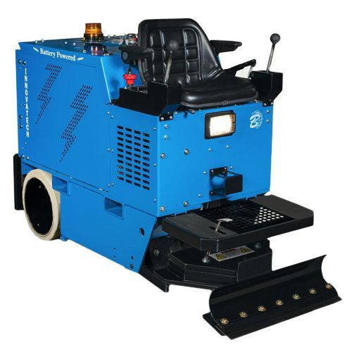 A blue machine with a black seat is sitting on a white surface.