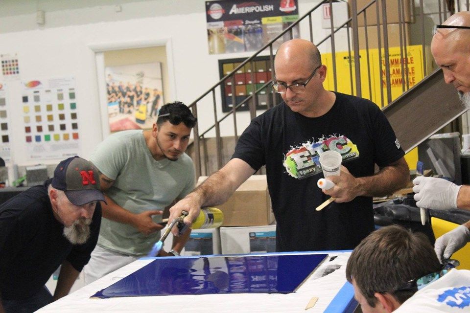 A group of men are working on a project in a room.