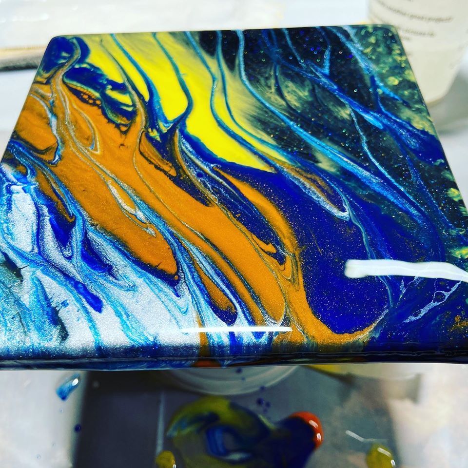 A blue and yellow painting is sitting on a table