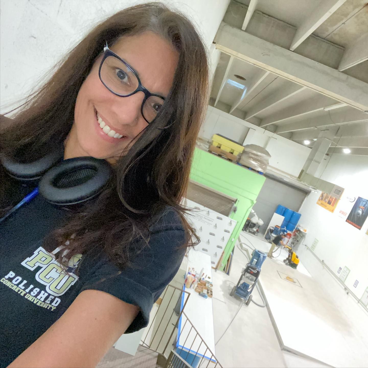 A woman wearing headphones and a t-shirt that says fcu on it