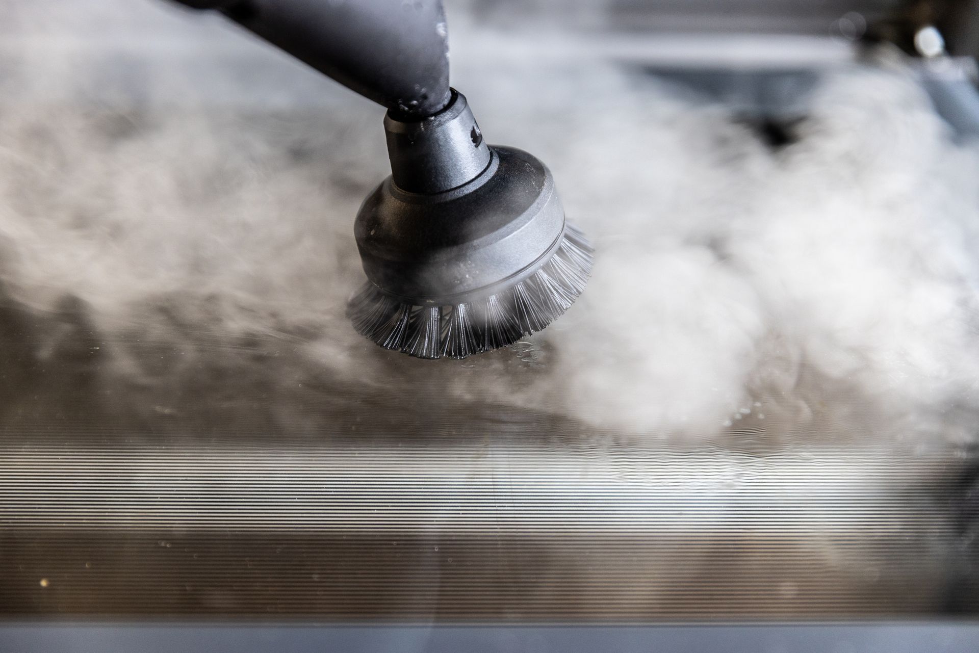 View of a steam cleaning tool disinfecting a a surface. View of a steam cleaning tool disinfecting a a surface.