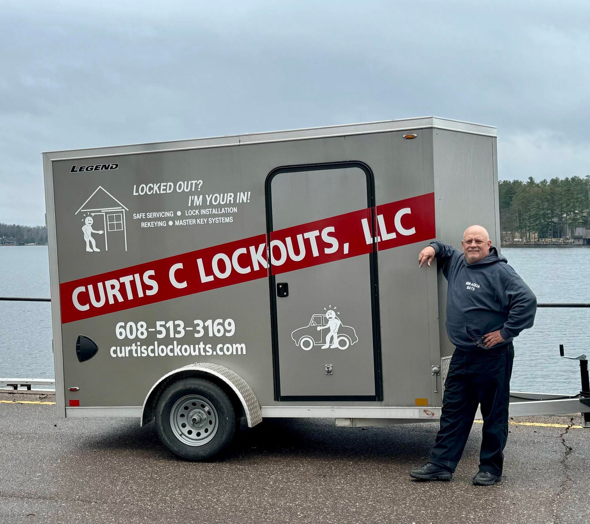 Man leaning on a grey trailer with 