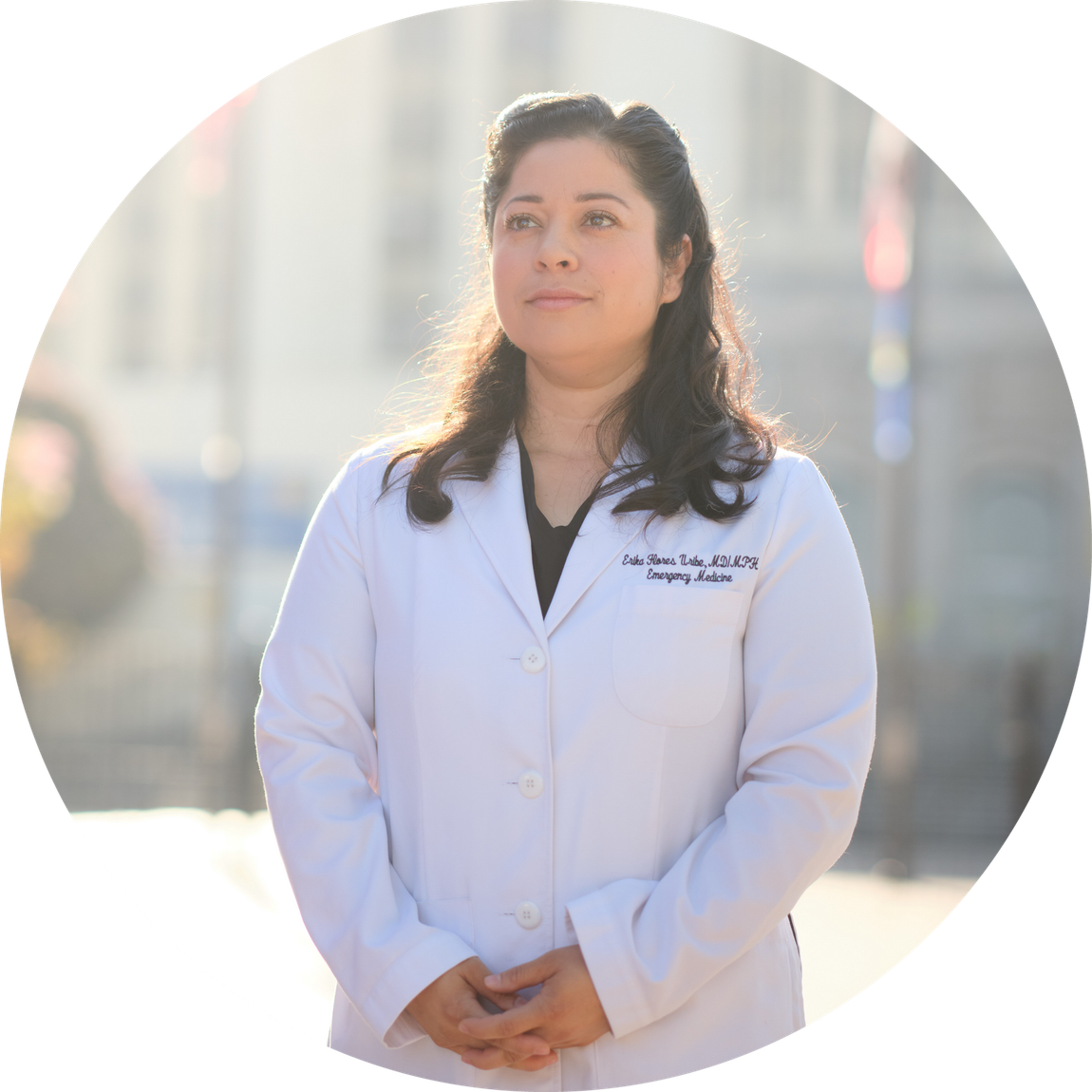 A woman in a white lab coat is standing in a circle.