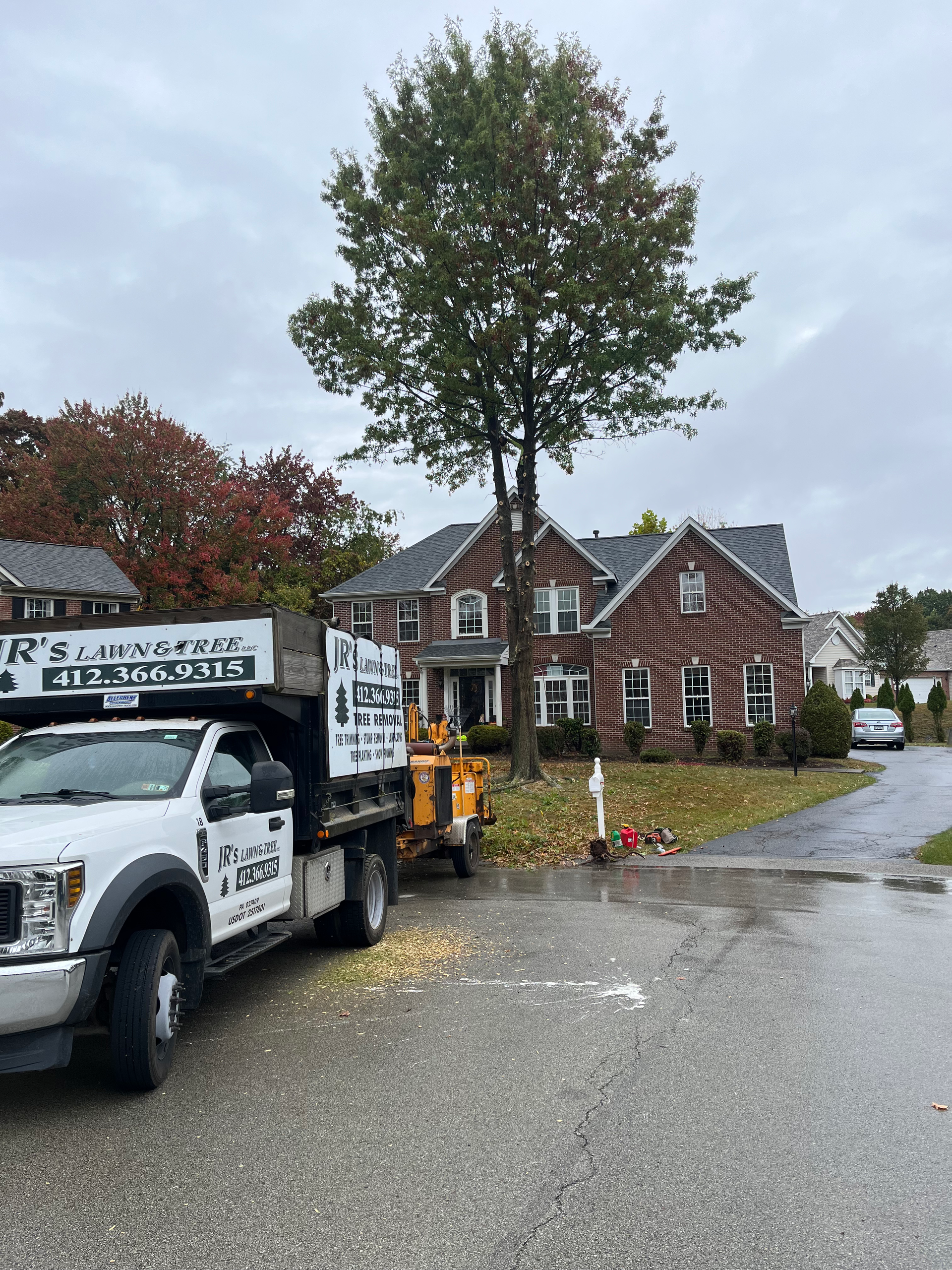 a white truck is parked in front of a brick house .