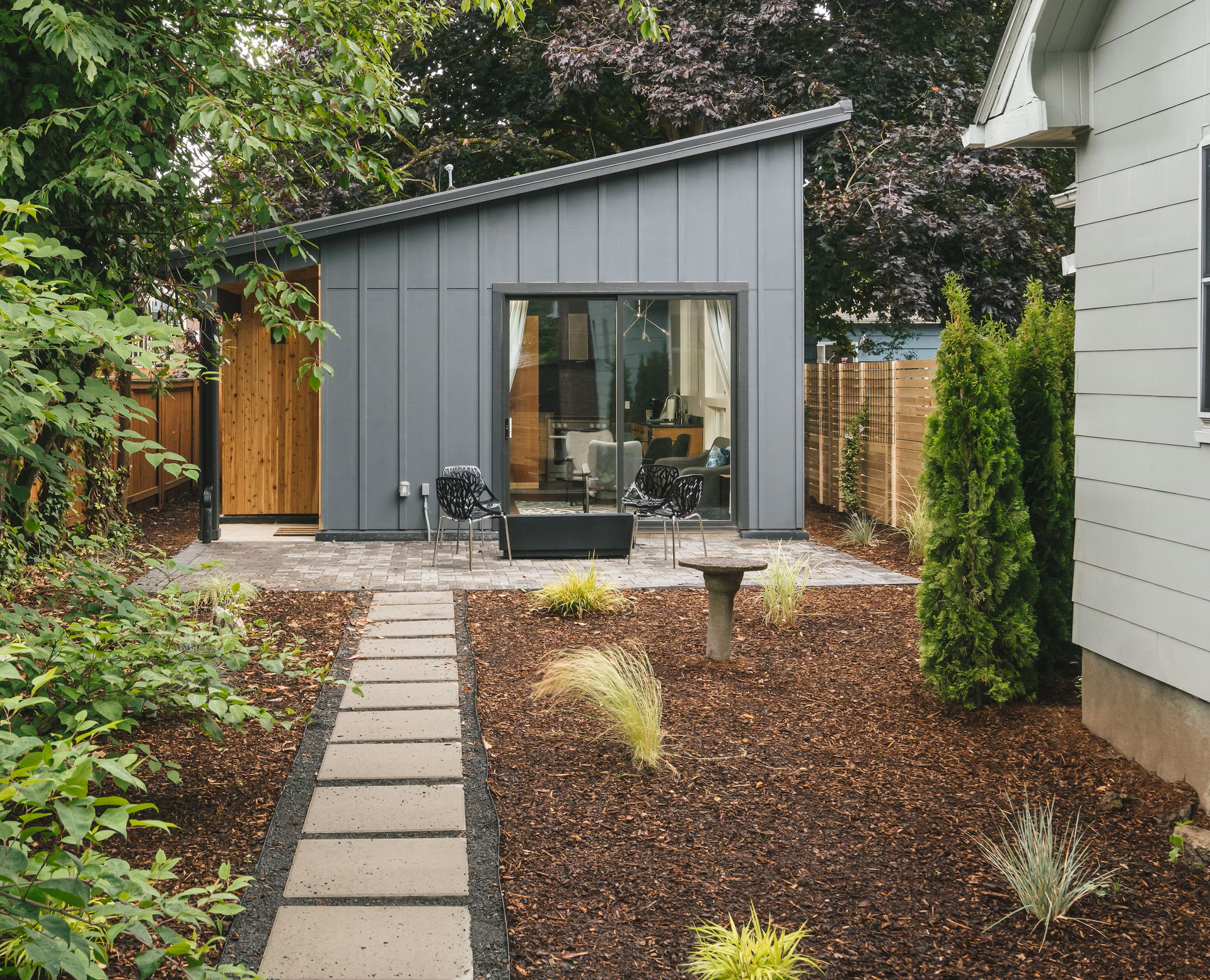 Exterior view of a tiny home, also known as an ADU (Accessory Dwelling Unit) or little house, nestled in a serene natural setting.