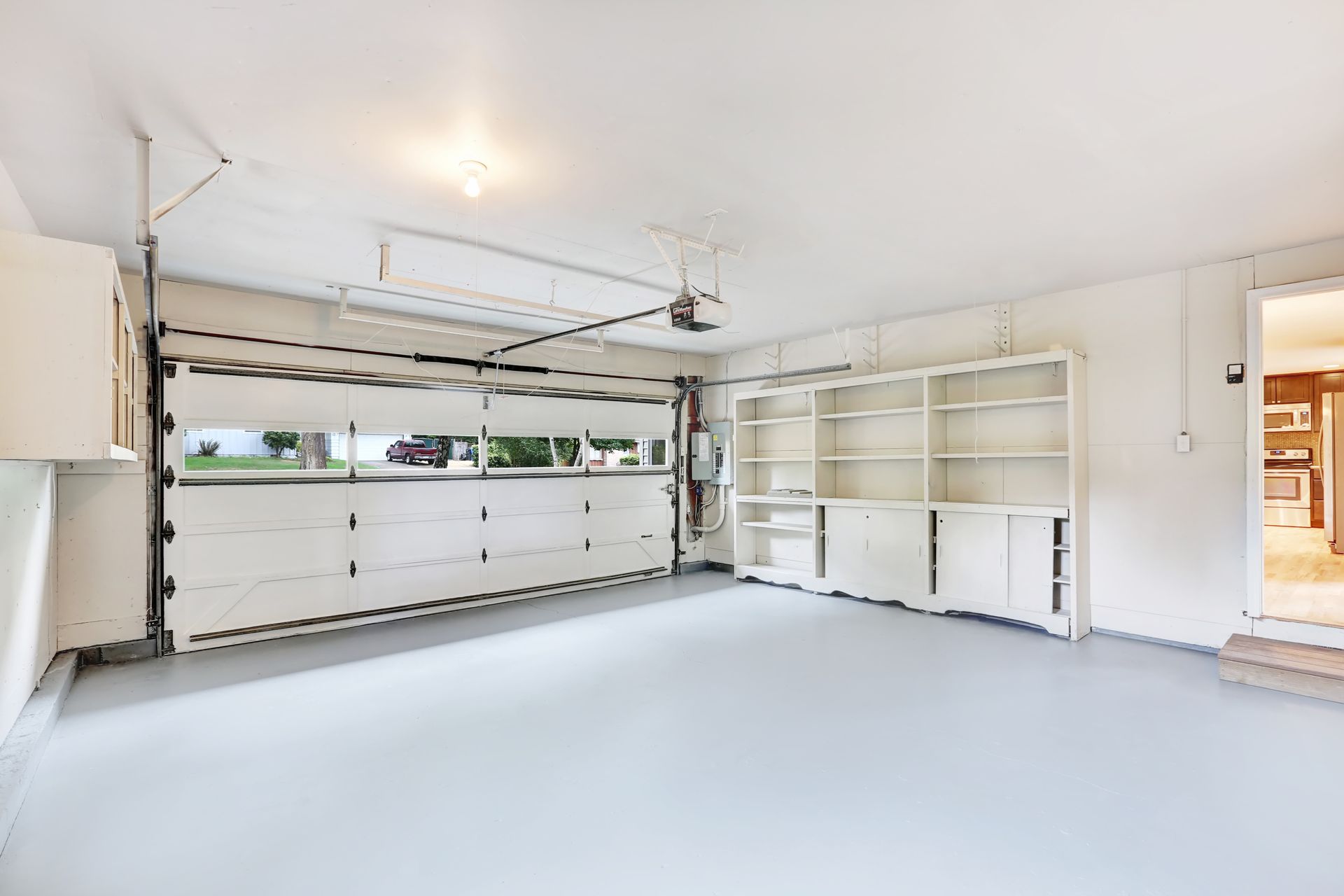 Spacious, well-lit garage interior in an American house with no vehicles or clutter, ready for storage or use.