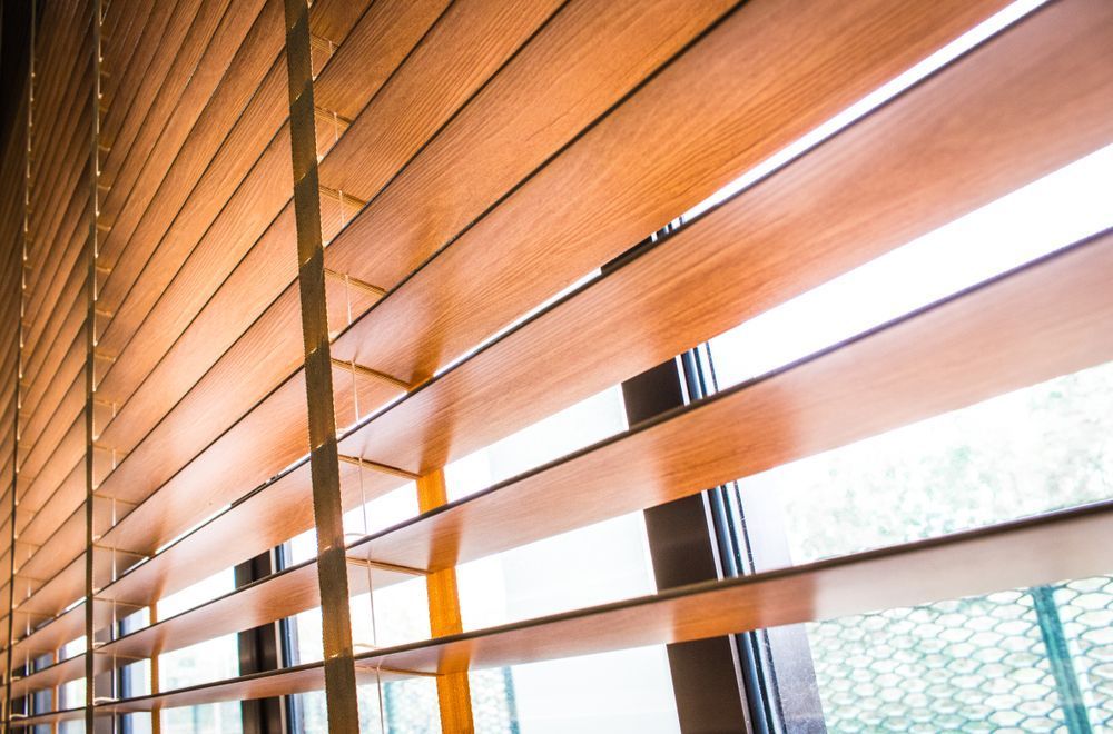 A Close Up of a Wooden Blind on a Window — Instyle Curtains & Blinds in Bungalow, QLD