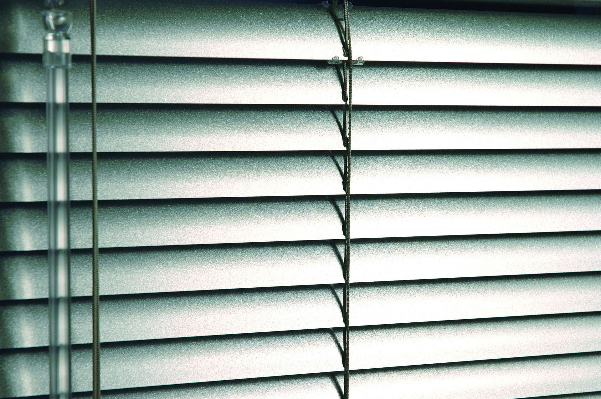 Silver horizontal blinds, close-up.