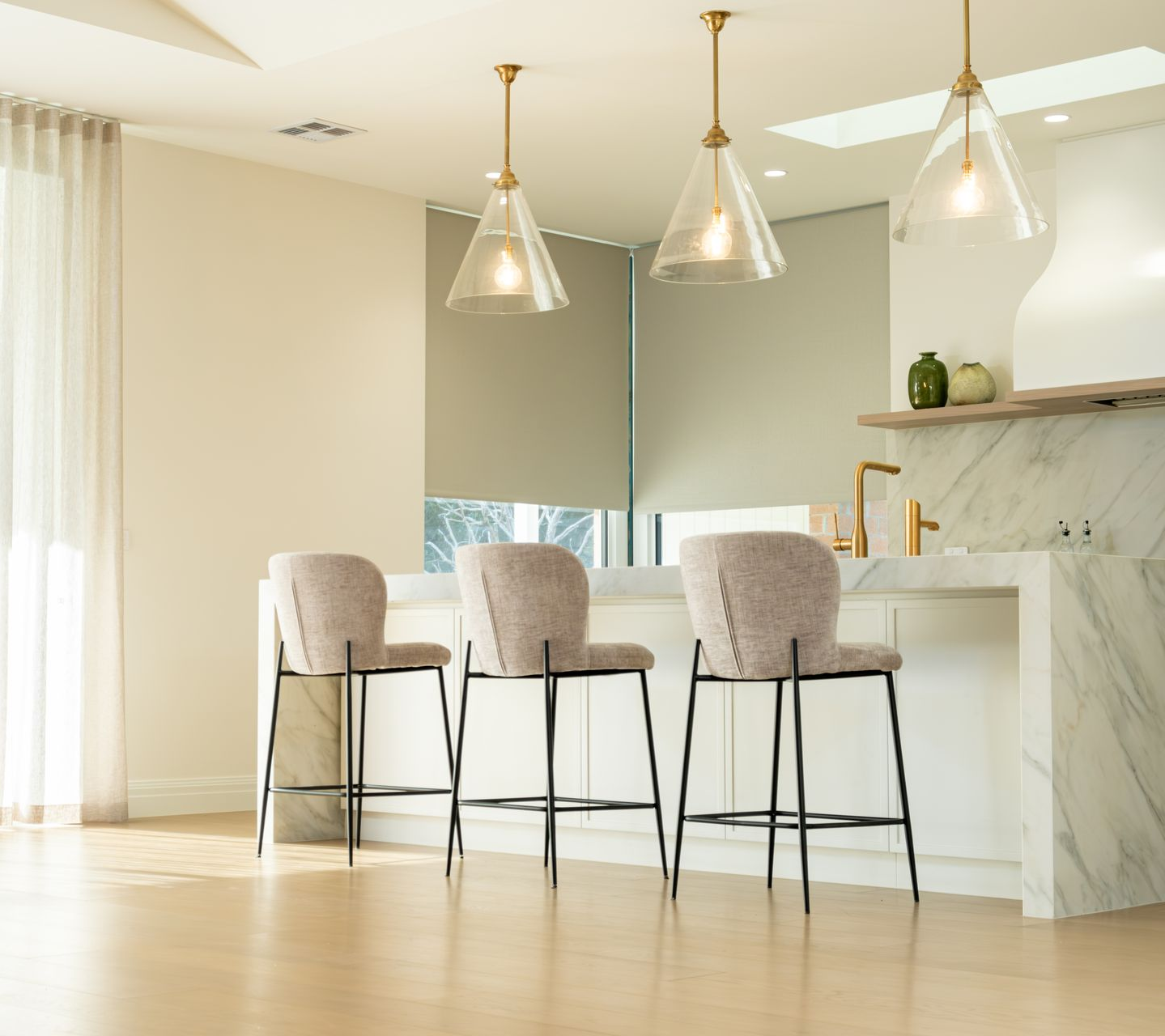 Bedroom with bed, bench, rug, nightstand, and window with blinds.