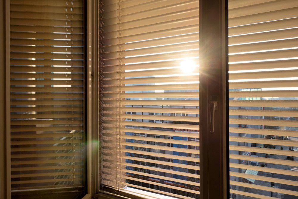 Sun Blinds are Attached to a Window — Instyle Curtains & Blinds in Bungalow, QLD