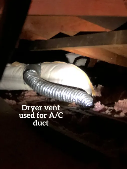 A flexible metallic dryer vent hose is incorrectly connected to an insulated A/C duct in an attic.