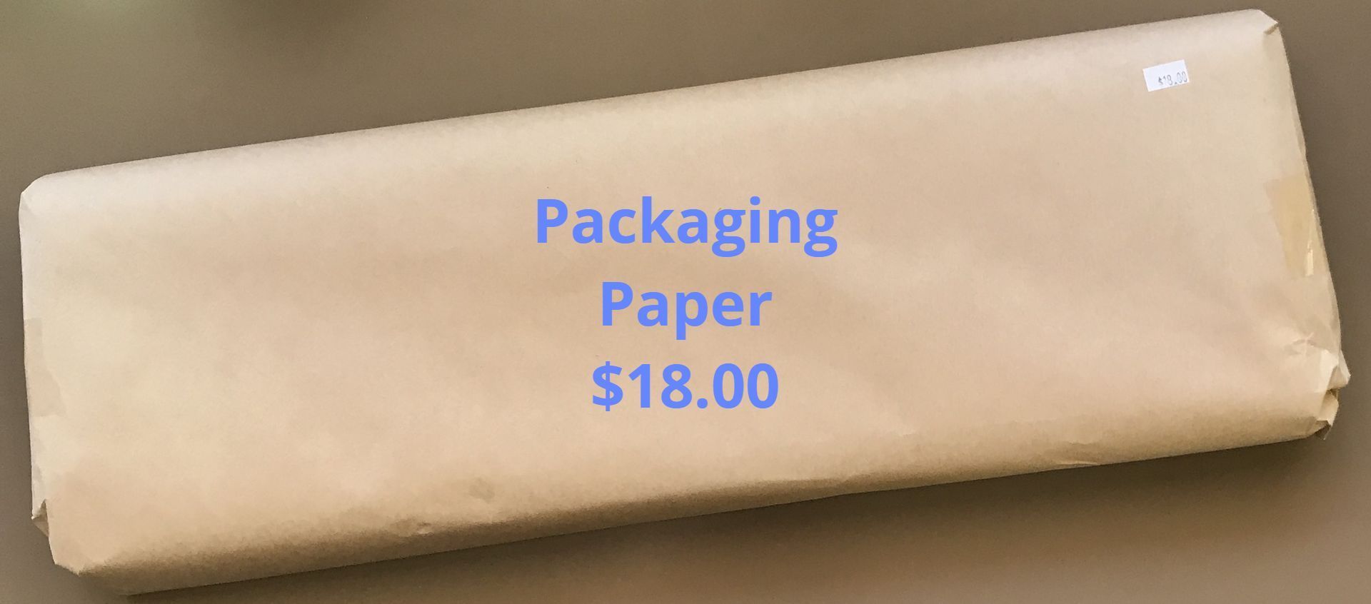 Packaging paper, brown, $18.00, on a neutral surface.