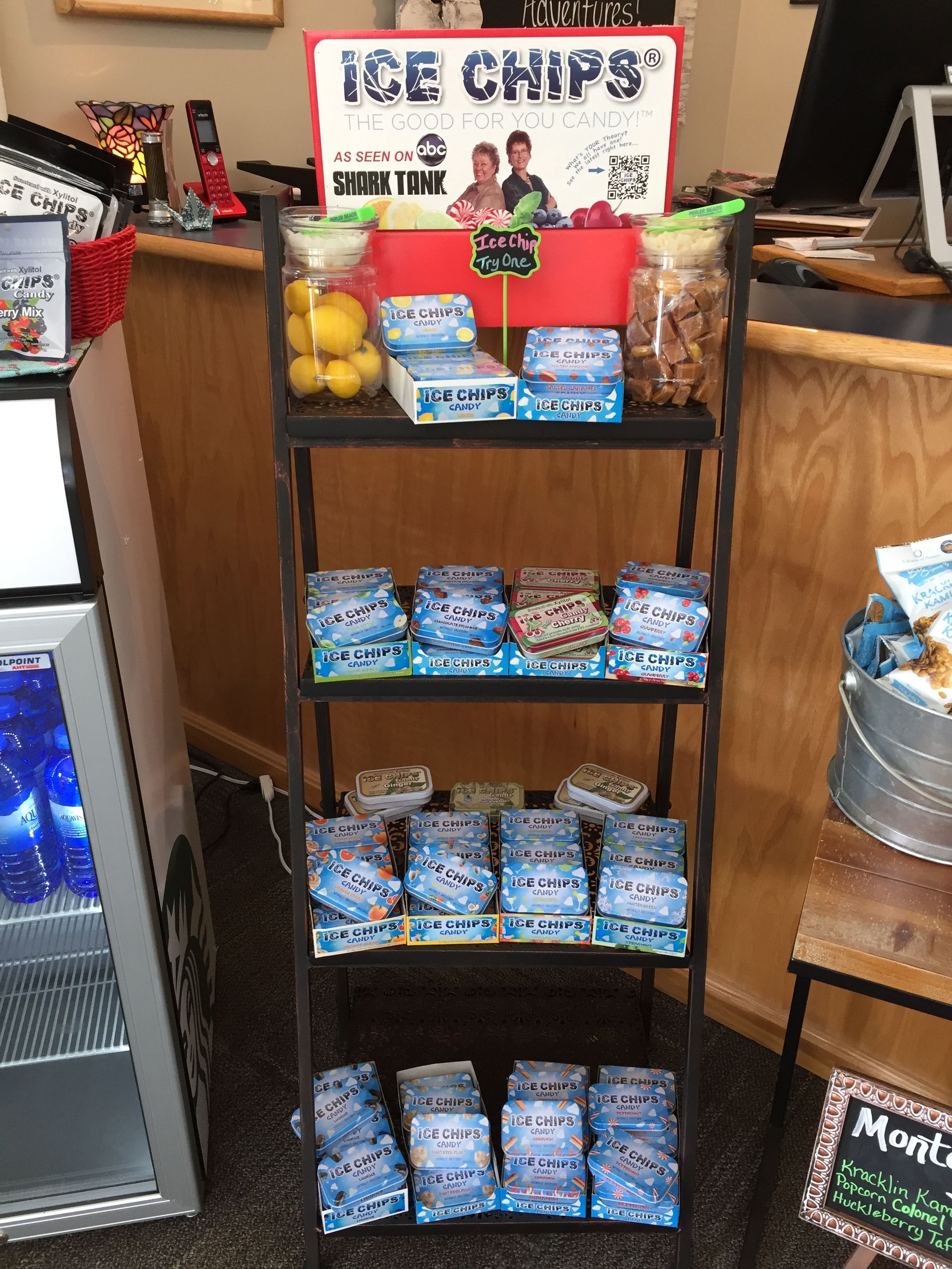 A display of ice chips is on a shelf in a store.