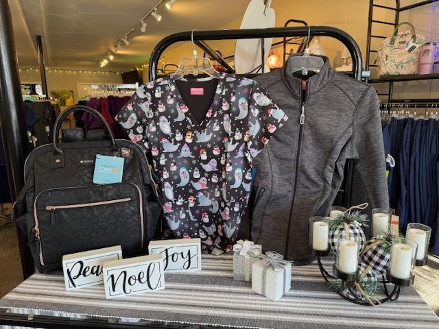 A red shirt and red pants are sitting on a white blanket.