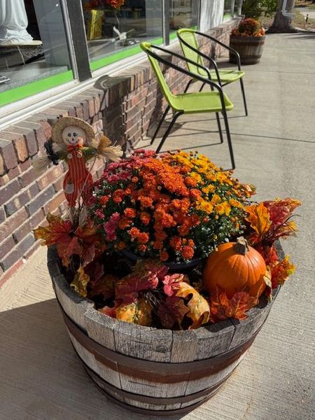 A mannequin wearing a scrub top and a pink hat