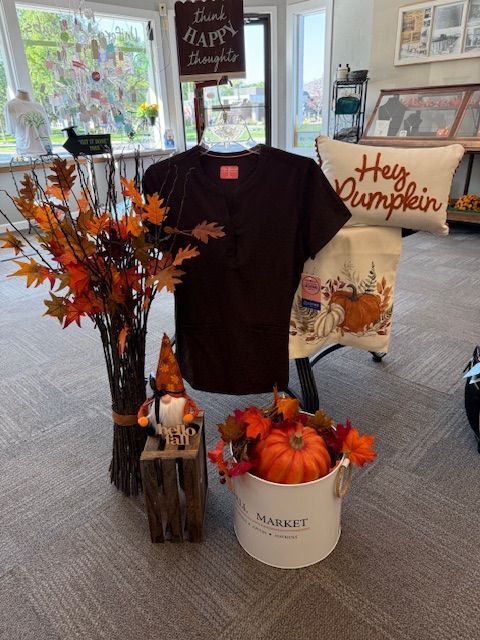 A red shirt and red pants are sitting on a white blanket.