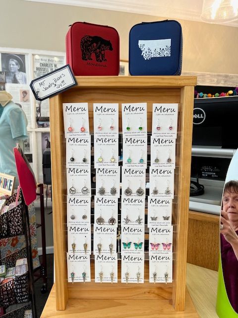 A display case filled with many different types of earrings