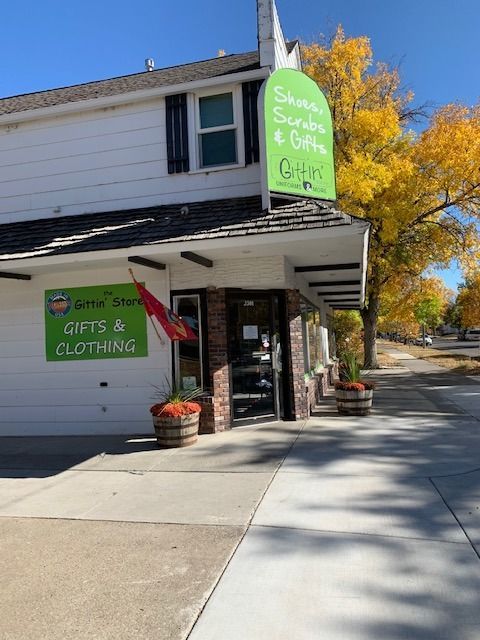 A store front with a sign that says gifts and clothing