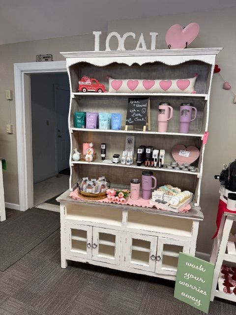 A table with a striped table cloth and cards on it in a store.
