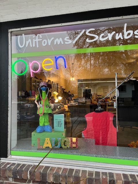 A store window with uniforms and scrubs written on it