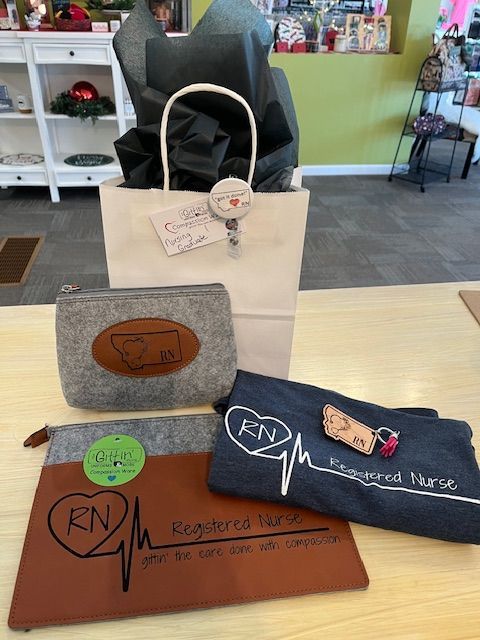 A white bag with a heartbeat on it is sitting on a table with other items.