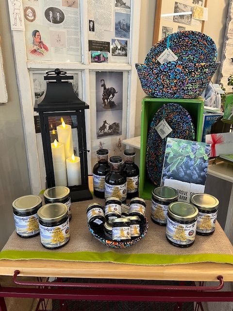 A table with jars of jam and candles on it.