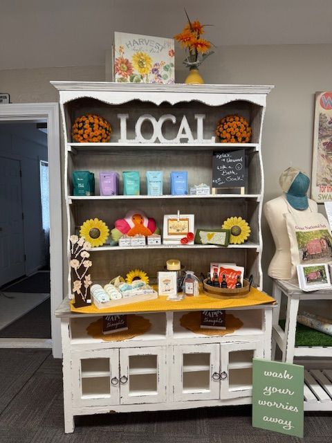 A table with a striped table cloth and cards on it in a store.