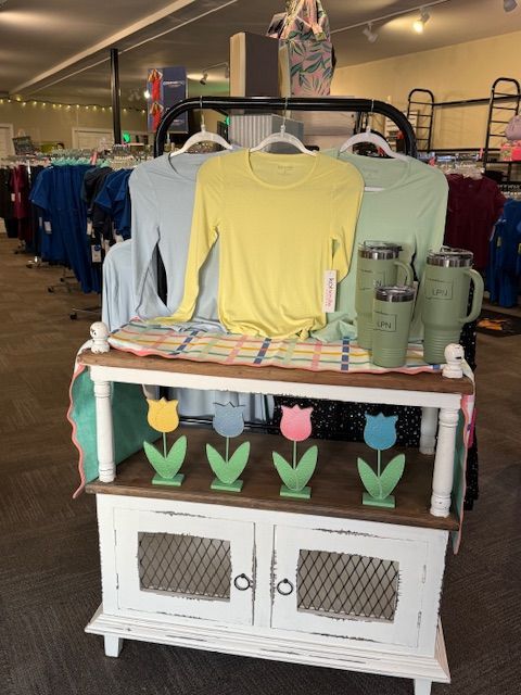 A red shirt and red pants are sitting on a white blanket.