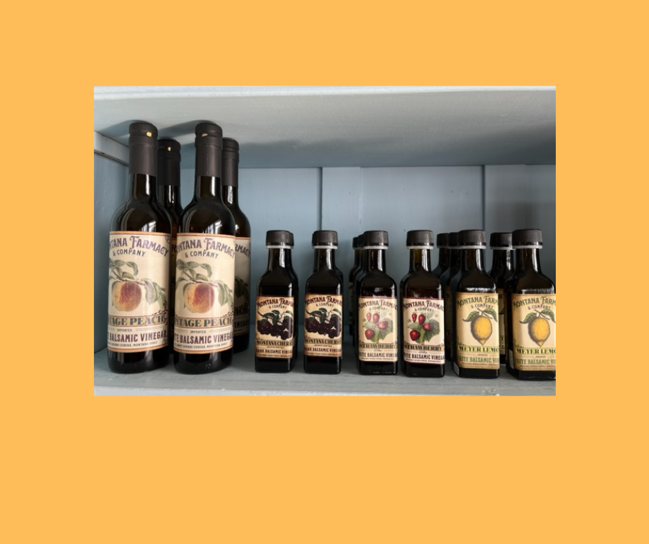 A shelf filled with bottles of different types of sauces.