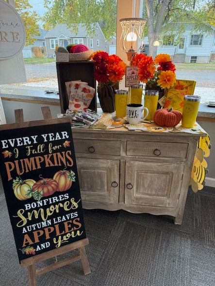 A table with a pillow that says happy pumpkin on it