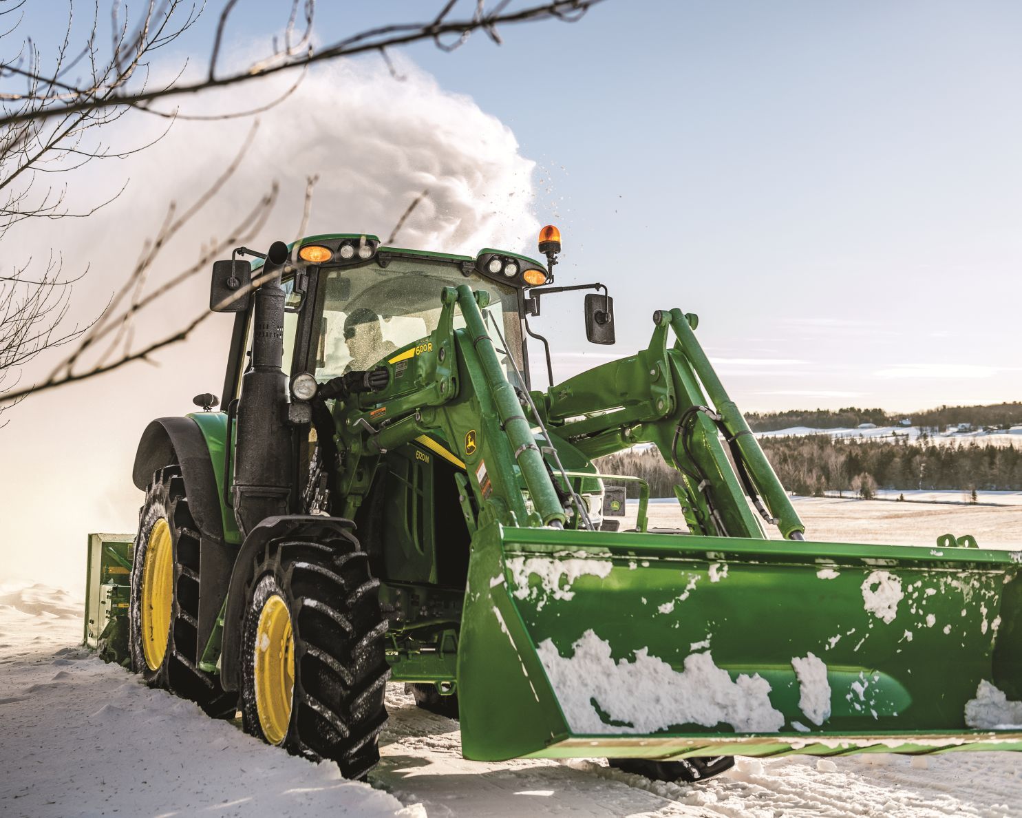 John Deere 6000 series tractor moves snow