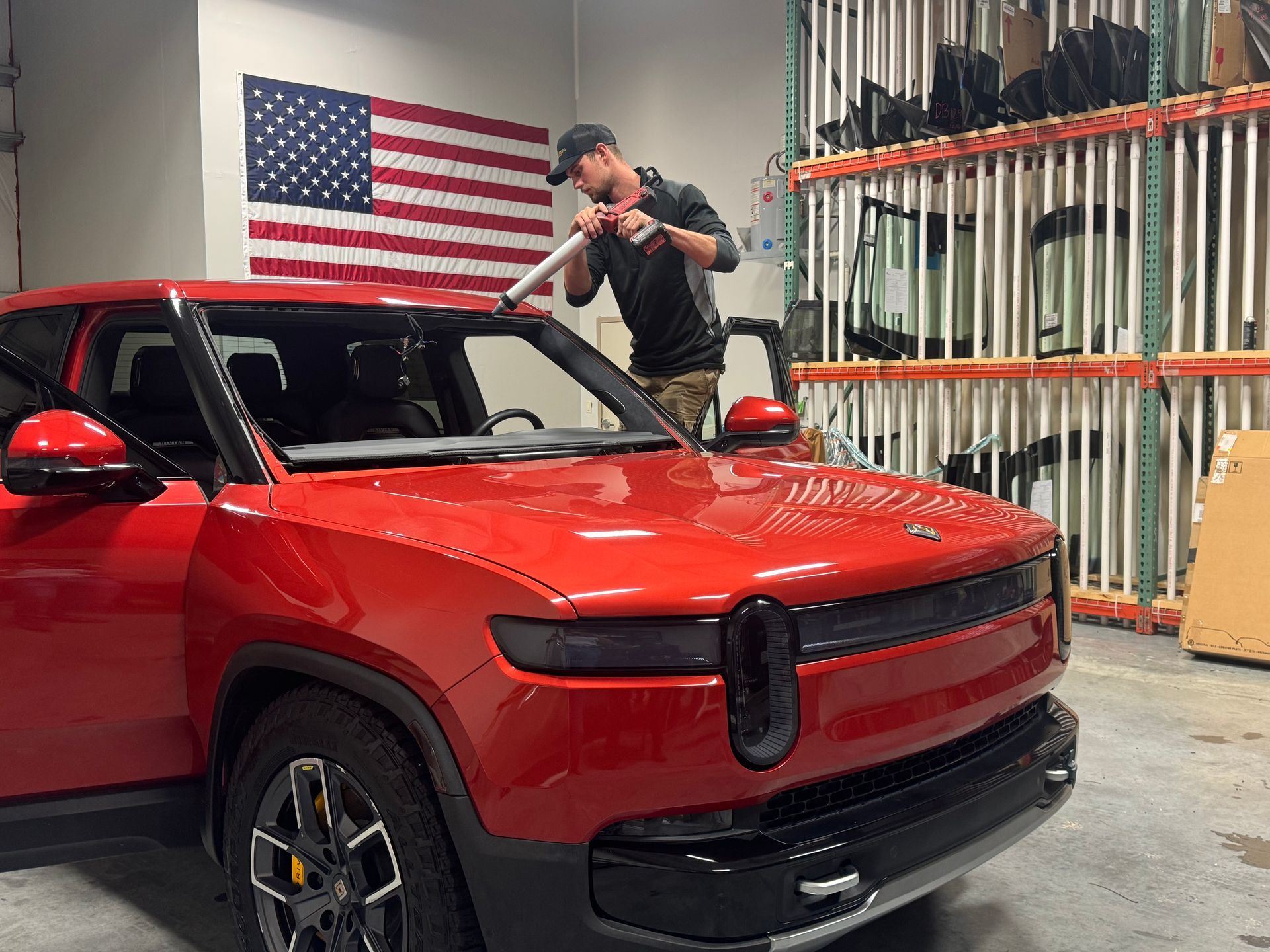 A man is installing a windshield on a car.