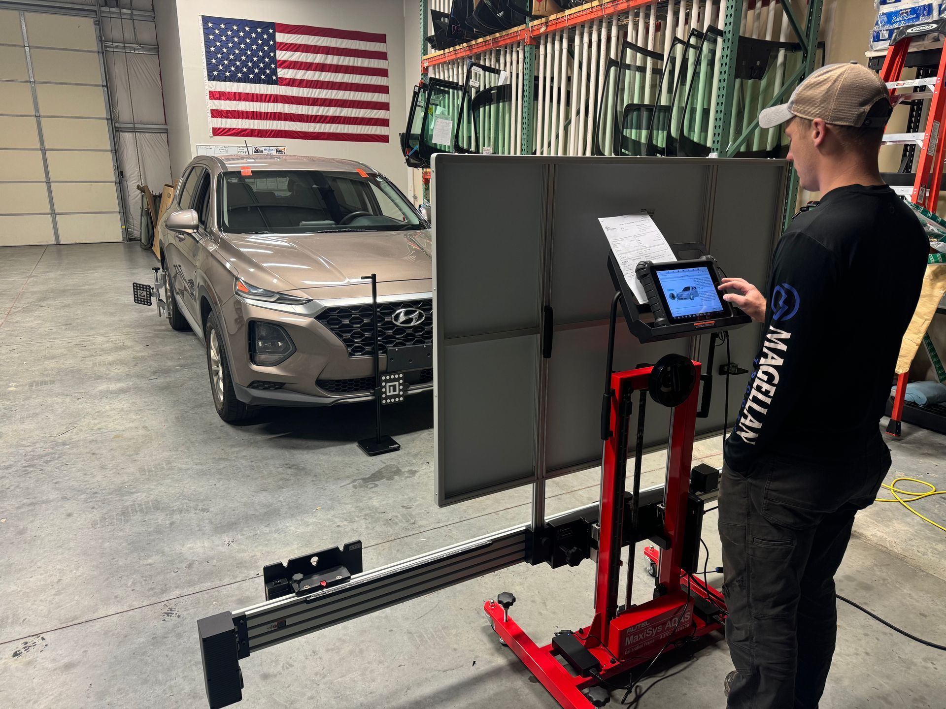 A man is driving a car and pressing a button on the dashboard.