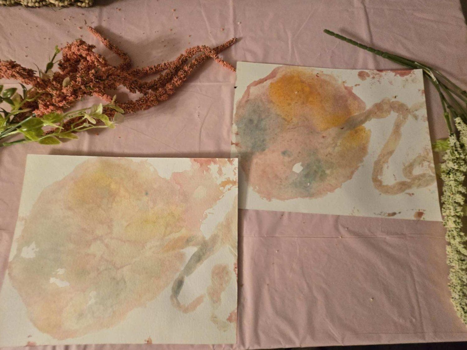 A painting of a baby 's umbilical cord is on a table with flowers