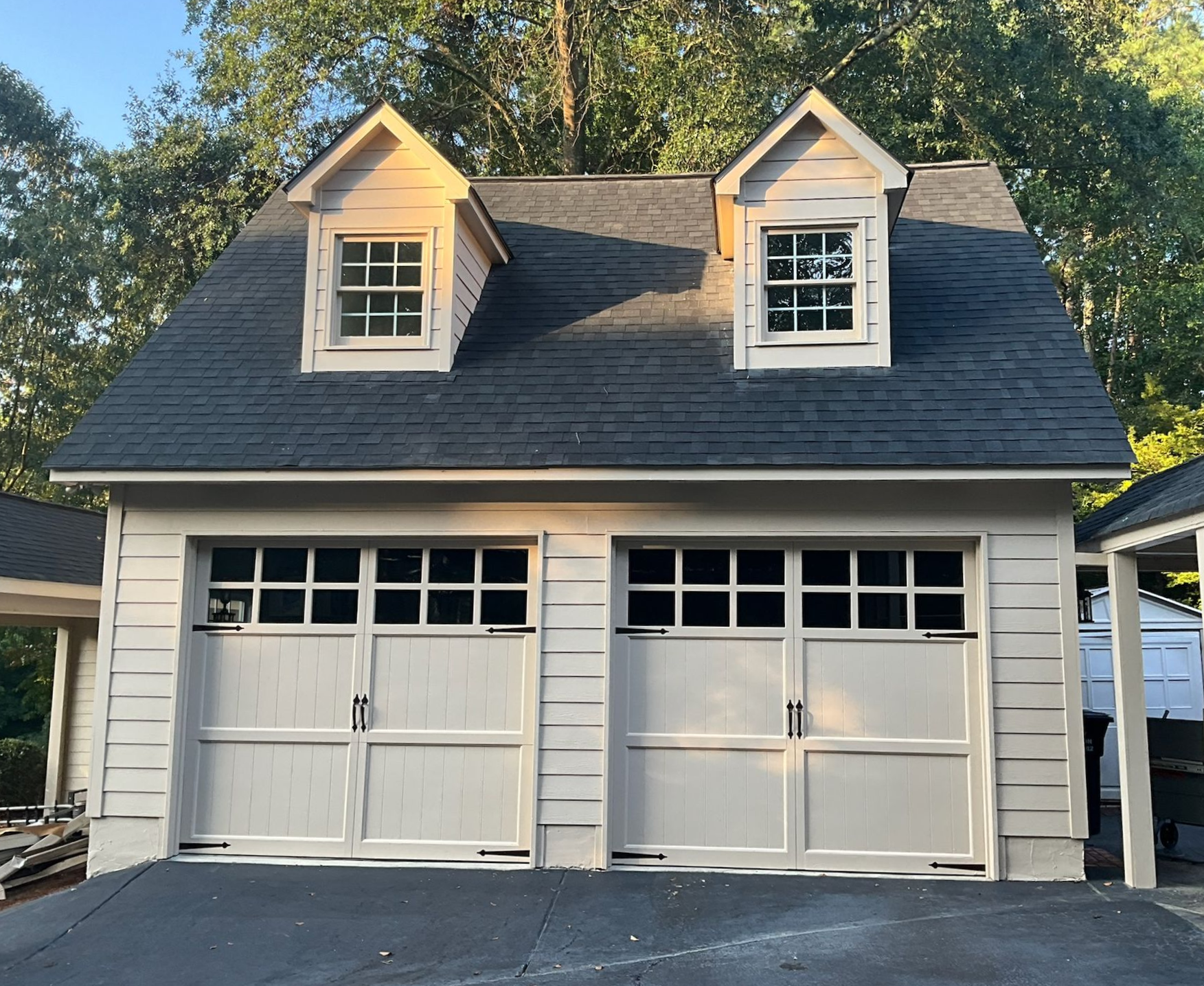 A kitchen with a wooden table and white chairs
