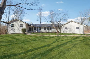 A balcony with wicker chairs and potted plants