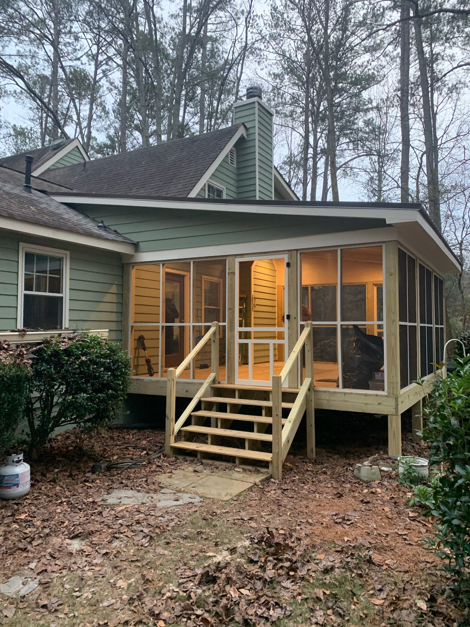 A large house with a large porch and a chimney