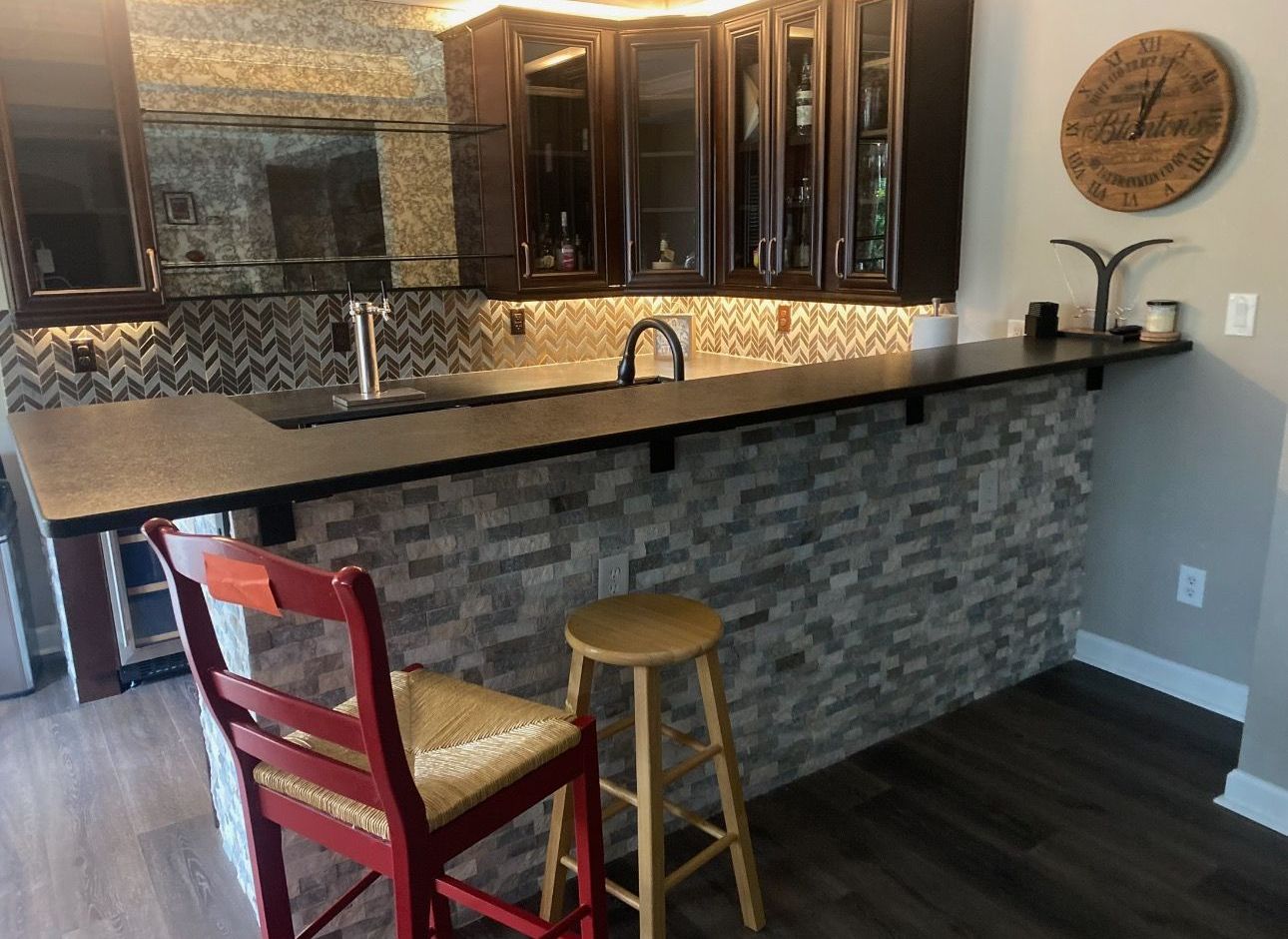 A kitchen with a wooden table and white chairs
