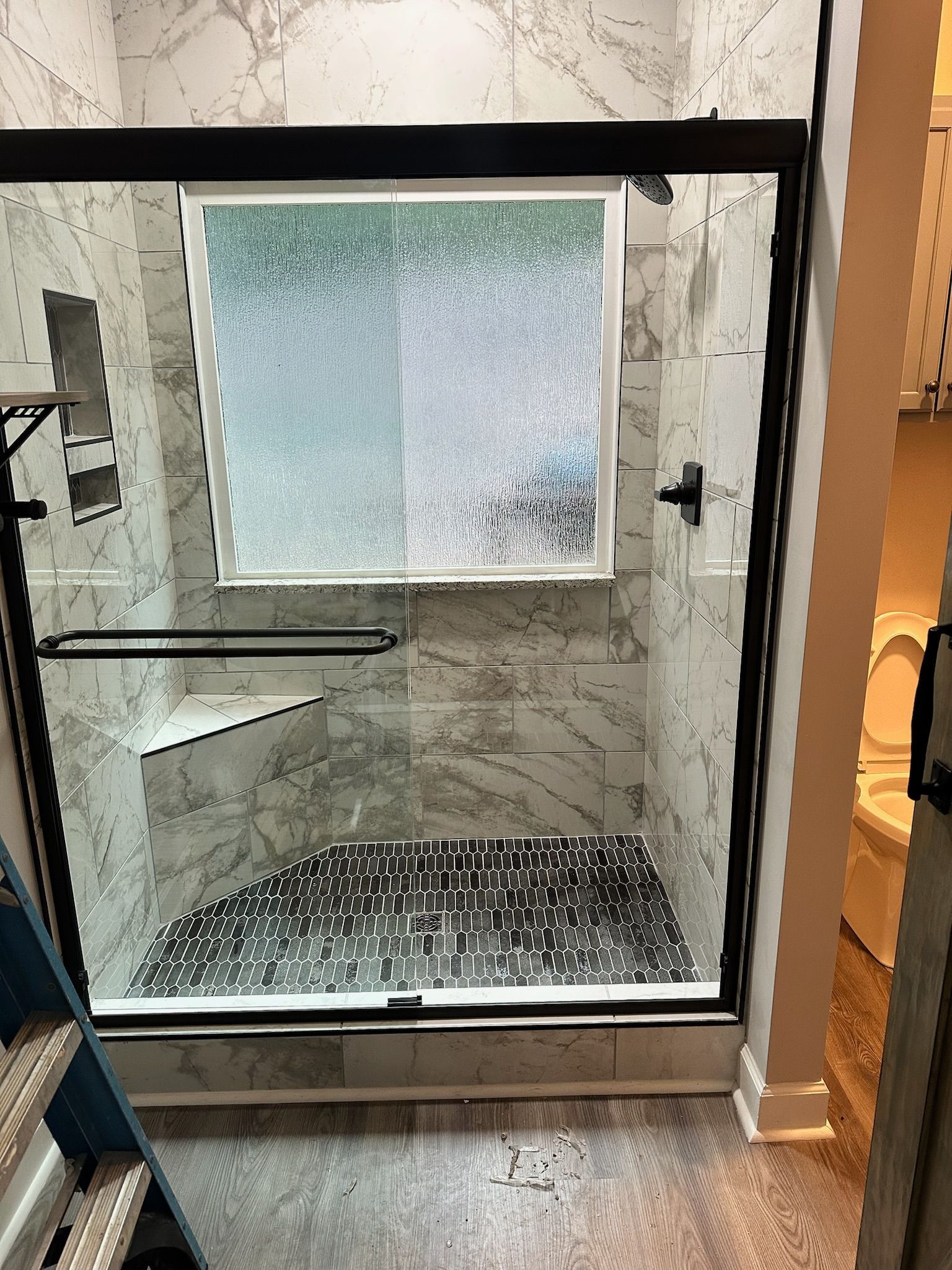 A bathroom with a tub , toilet , sink and shower.