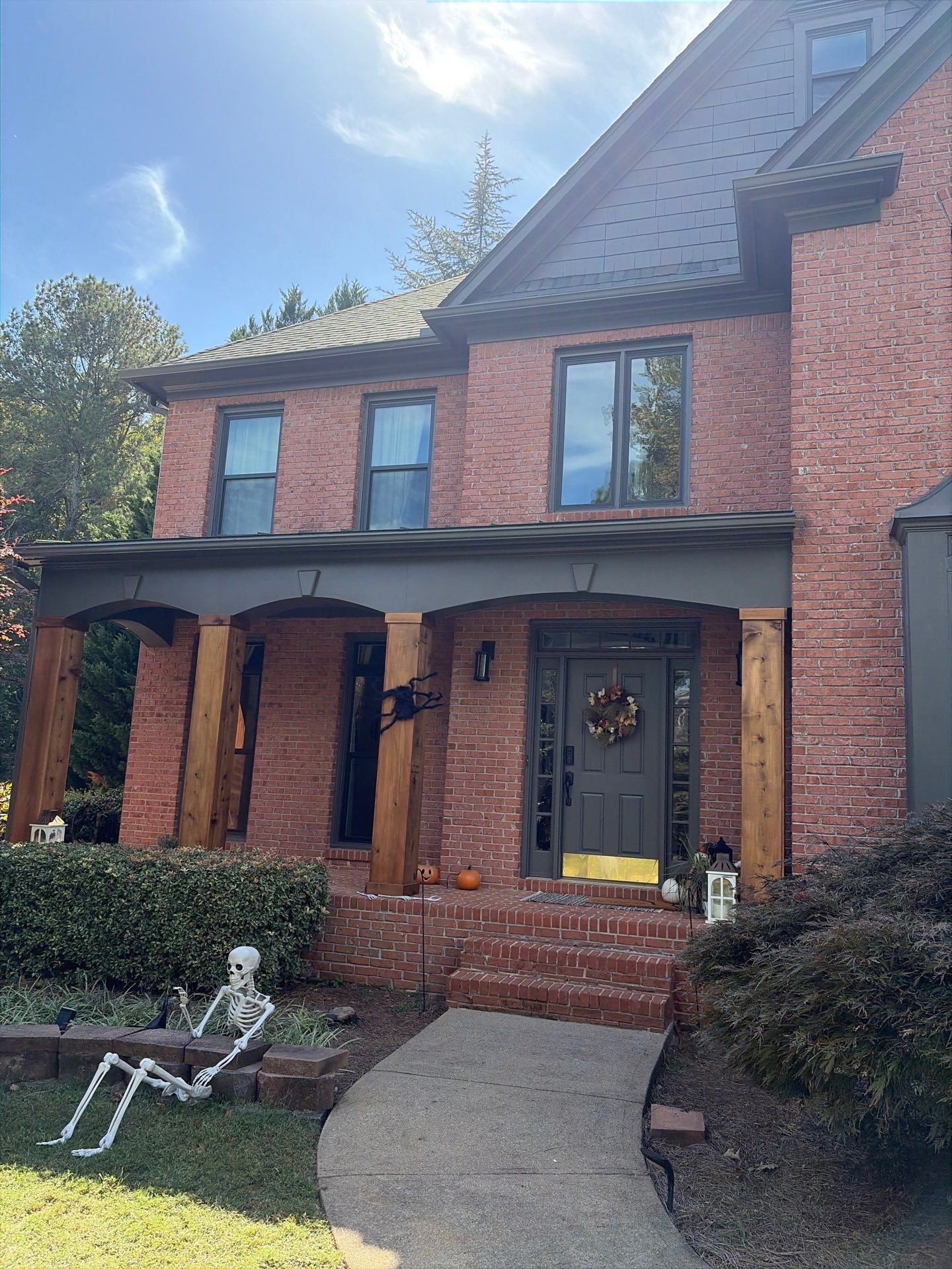 A large house with a fence and lots of windows
