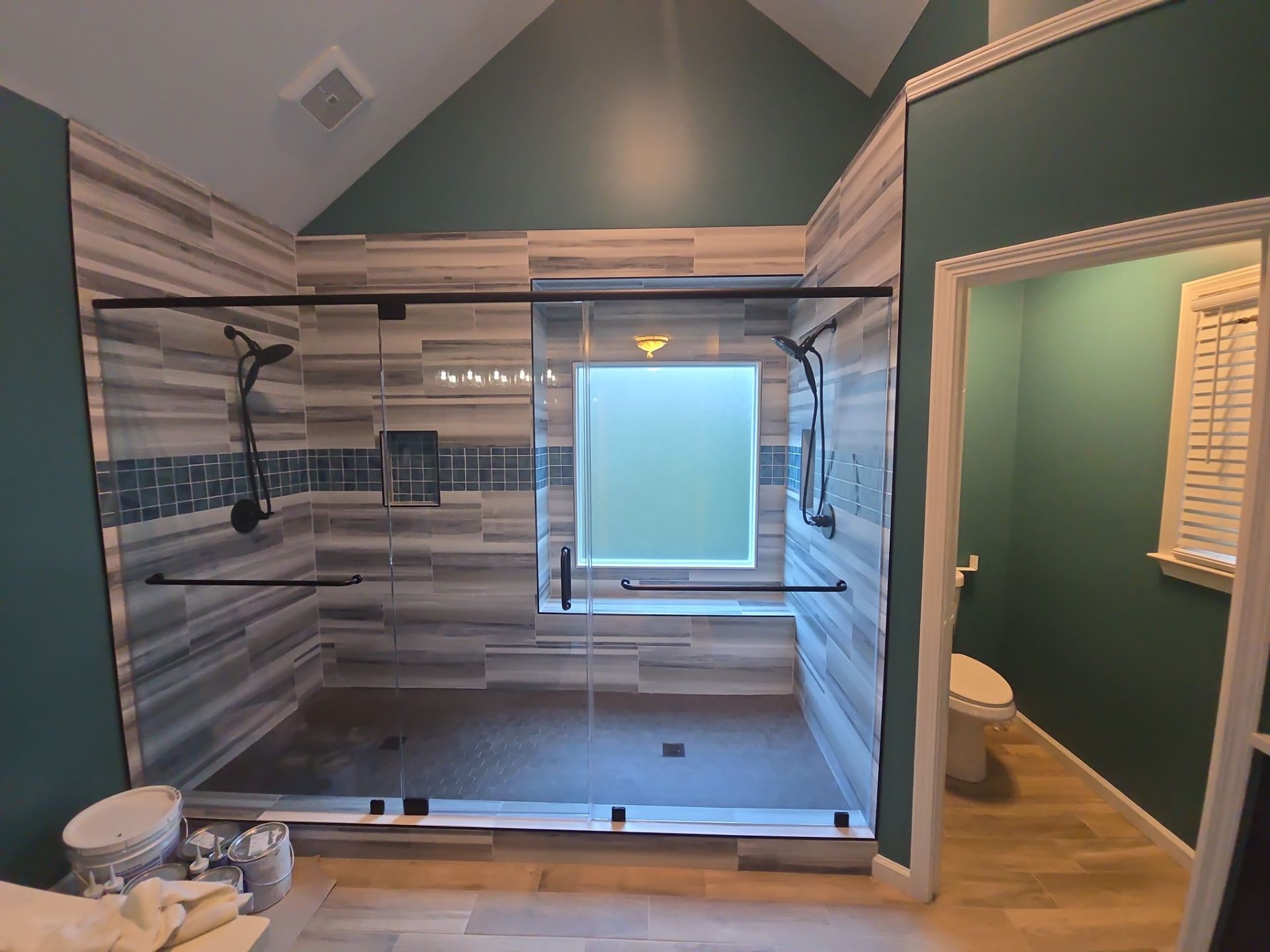 A kitchen with black cabinets and a copper sink