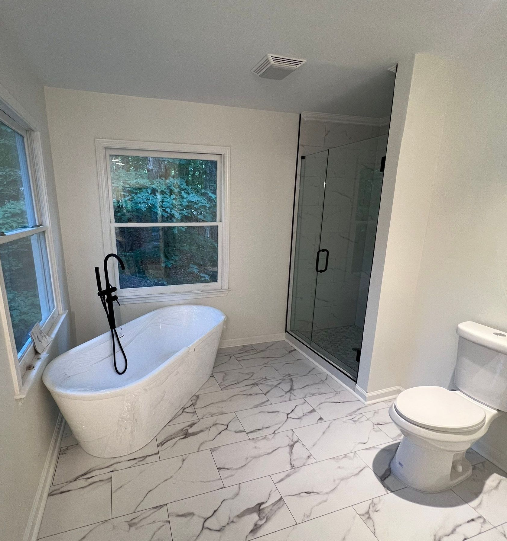 A room with drywall and a bucket of ag paint