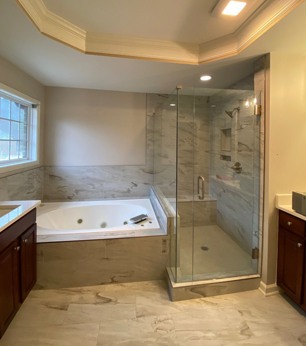 A bathroom with a walk in shower and a window