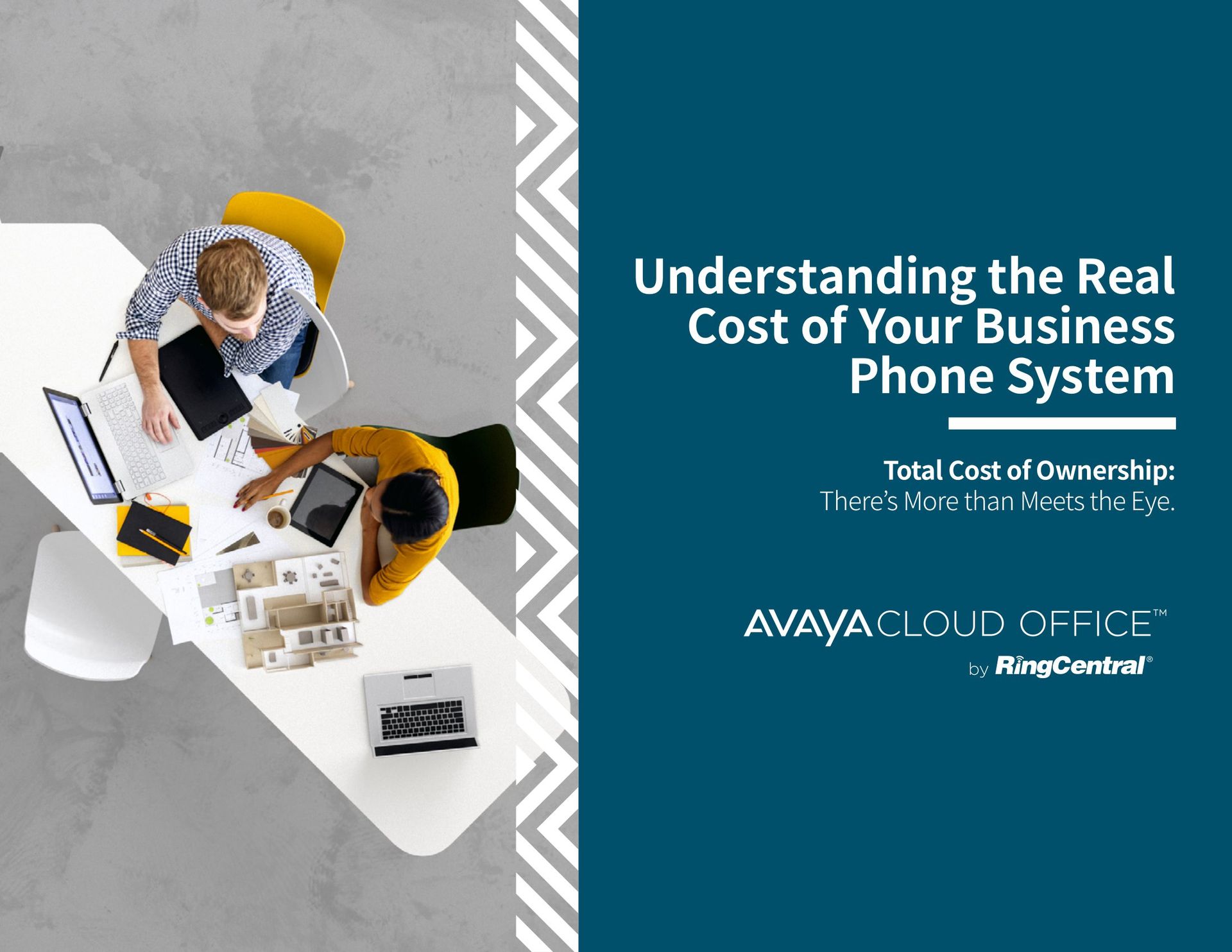 Two people are sitting at a table with laptops and tablets.