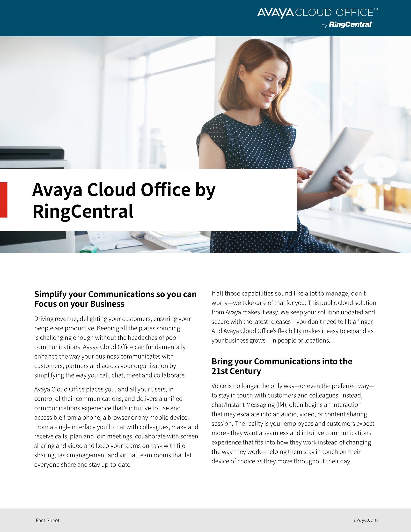 A woman is sitting at a desk holding a tablet.